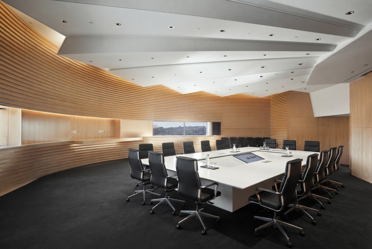 Empty boardroom with a long white conference table